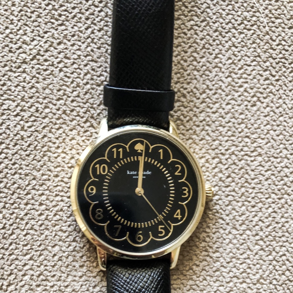 Black kate spade watch with scalloped face.